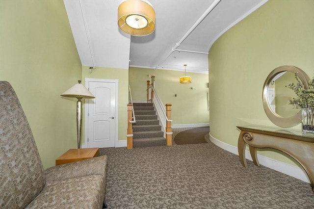 stairway featuring carpet flooring and baseboards
