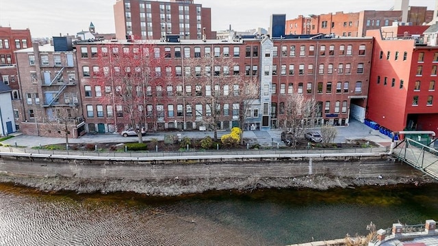 view of property featuring a water view and a city view