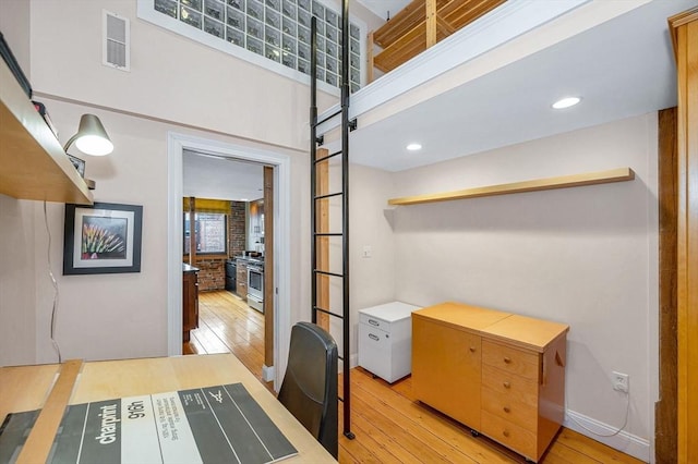office area featuring visible vents, a healthy amount of sunlight, and light wood-style flooring