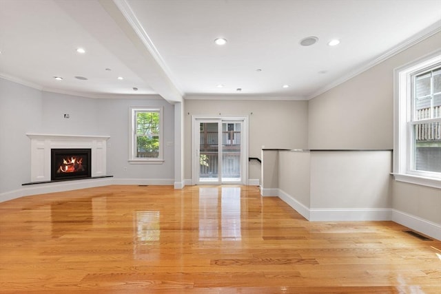 20 Winfield St Unit 1, Boston, MA 02127 - unfurnished living room with light wood-style flooring, ornamental molding, a glass covered fireplace, and recessed lighting