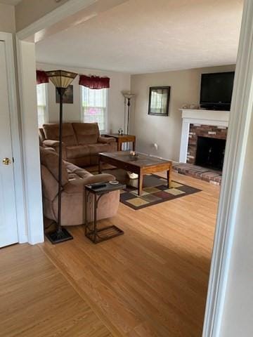 19 Camelot Ct Unit 19, Stoughton, MA 02072 - living area with a brick fireplace and wood finished floors