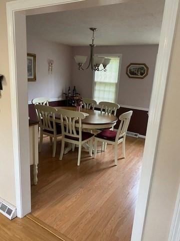 19 Camelot Ct Unit 19, Stoughton, MA 02072 - dining area featuring light wood-type flooring and a chandelier