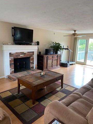 19 Camelot Ct Unit 19, Stoughton, MA 02072 - living area featuring light wood-style floors, a fireplace, and ceiling fan