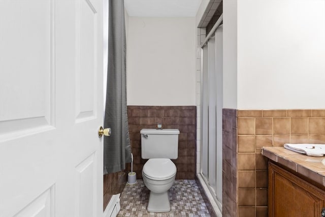 19 Camelot Ct Unit 19, Stoughton, MA 02072 - full bathroom with tile walls, toilet, a stall shower, vanity, and a wainscoted wall