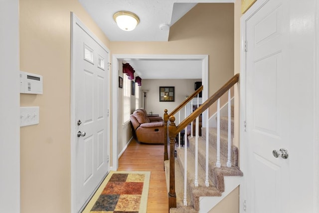 19 Camelot Ct Unit 19, Stoughton, MA 02072 - foyer entrance featuring light wood-style flooring, stairs, and baseboards