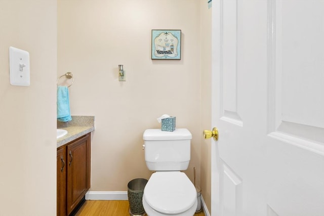 19 Camelot Ct Unit 19, Stoughton, MA 02072 - bathroom featuring vanity, toilet, baseboards, and wood finished floors