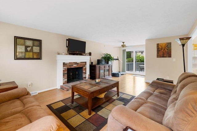 19 Camelot Ct Unit 19, Stoughton, MA 02072 - living area featuring light wood-style floors, baseboards, ceiling fan, and a fireplace