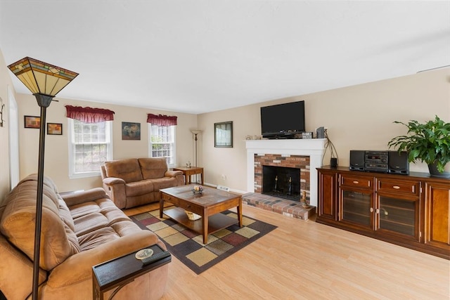 19 Camelot Ct Unit 19, Stoughton, MA 02072 - living area with light wood-style floors and a brick fireplace