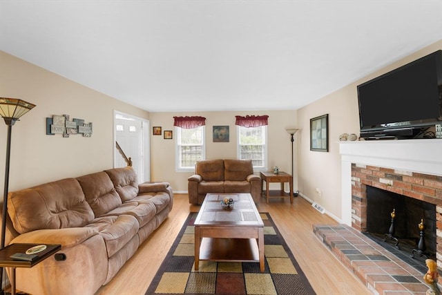 19 Camelot Ct Unit 19, Stoughton, MA 02072 - living area featuring light wood finished floors, a fireplace, and baseboards