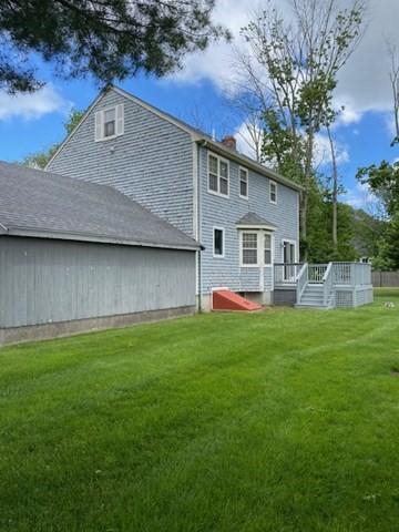 19 Camelot Ct Unit 19, Stoughton, MA 02072 - back of house with a wooden deck, a yard, and a chimney