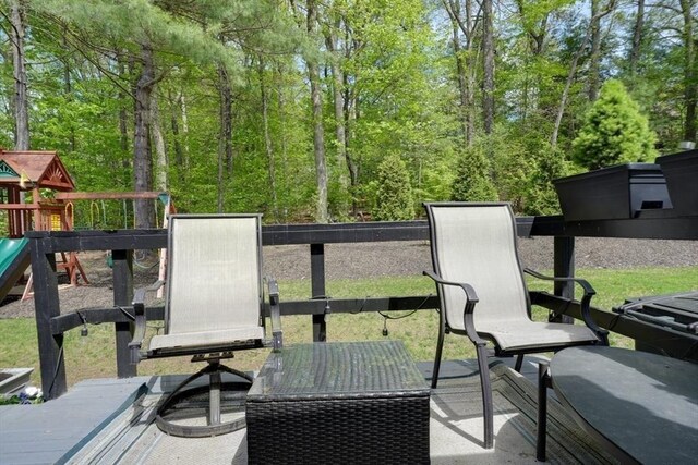 wooden deck featuring a playground