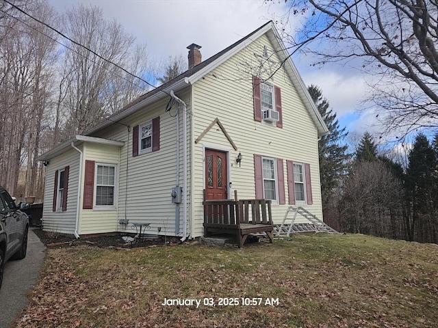 view of front of house featuring cooling unit and a front lawn