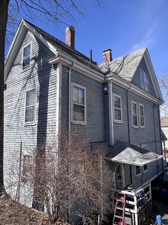 91 Tudor St, Chelsea, MA 02150 - view of side of property featuring a chimney