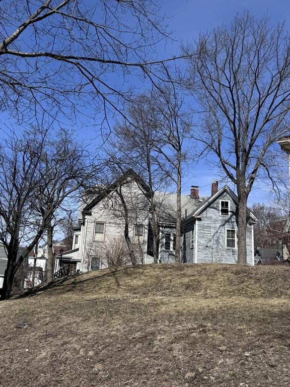 91 Tudor St, Chelsea, MA 02150 - view of side of home with a chimney