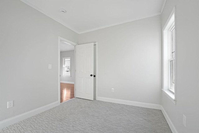 carpeted spare room featuring a wealth of natural light