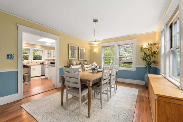 dining area with plenty of natural light, light wood-style flooring, and baseboards