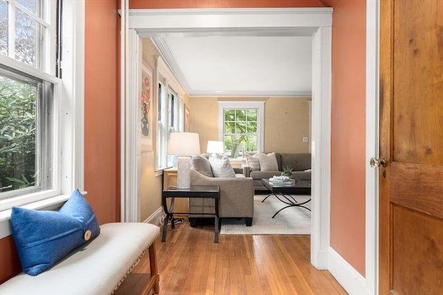living area with light wood-type flooring and baseboards