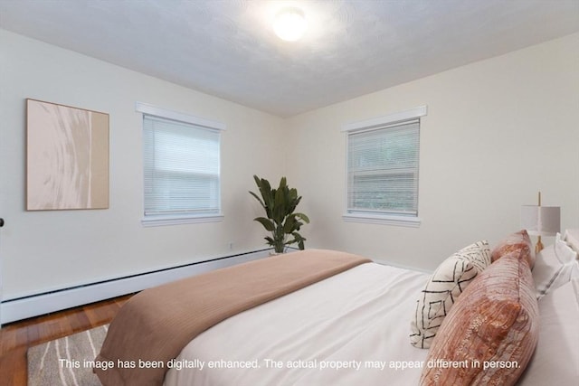 58 Aldrich Rd Unit A, Watertown, MA 02472 - bedroom with wood finished floors and a baseboard heating unit