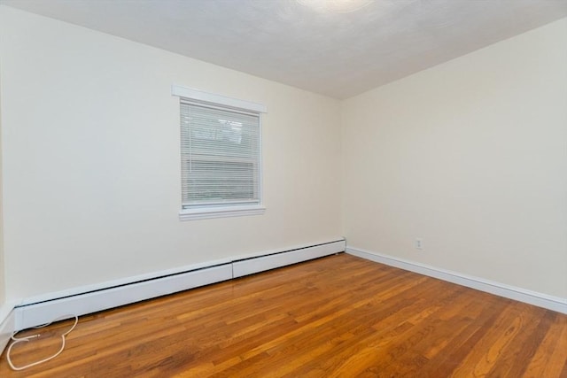 58 Aldrich Rd Unit A, Watertown, MA 02472 - spare room featuring a baseboard heating unit and wood finished floors