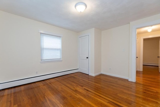 58 Aldrich Rd Unit A, Watertown, MA 02472 - spare room with a baseboard heating unit, baseboard heating, and wood finished floors