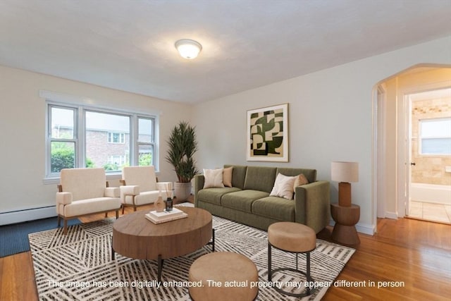 58 Aldrich Rd Unit A, Watertown, MA 02472 - living area featuring arched walkways, a baseboard heating unit, and wood finished floors