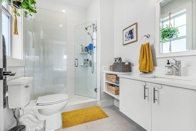 bathroom with tile patterned flooring, vanity, toilet, and a shower stall