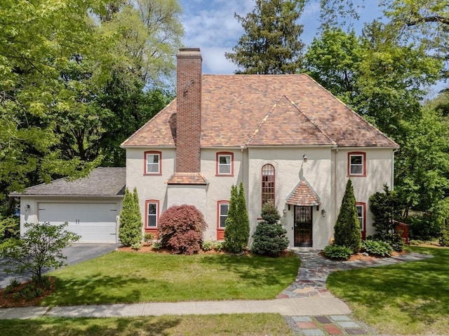 7 Argyle St, Worcester, MA 01609 - view of front of house with stucco siding, a chimney, asphalt driveway, and a front yard