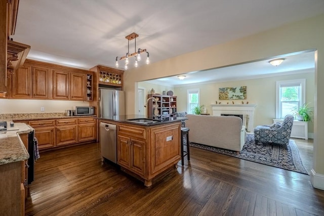 7 Argyle St, Worcester, MA 01609 - kitchen with a sink, appliances with stainless steel finishes, open floor plan, dark wood-style flooring, and brown cabinetry