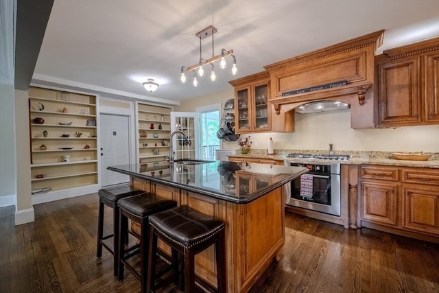 7 Argyle St, Worcester, MA 01609 - kitchen with appliances with stainless steel finishes, a sink, brown cabinets, and a kitchen breakfast bar