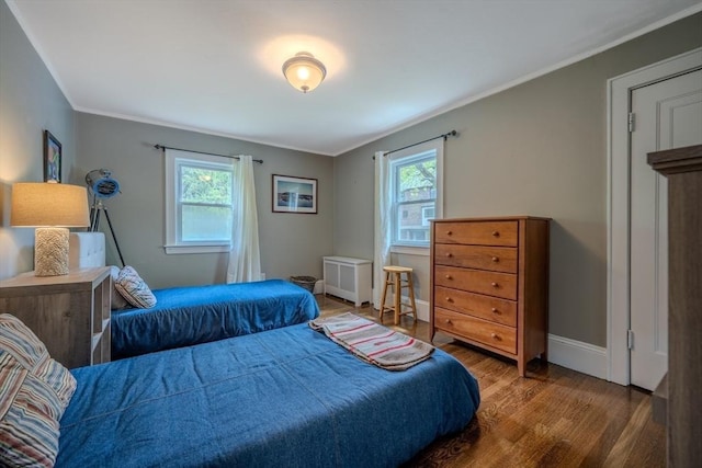 7 Argyle St, Worcester, MA 01609 - bedroom featuring wood finished floors, radiator, multiple windows, ornamental molding, and baseboards
