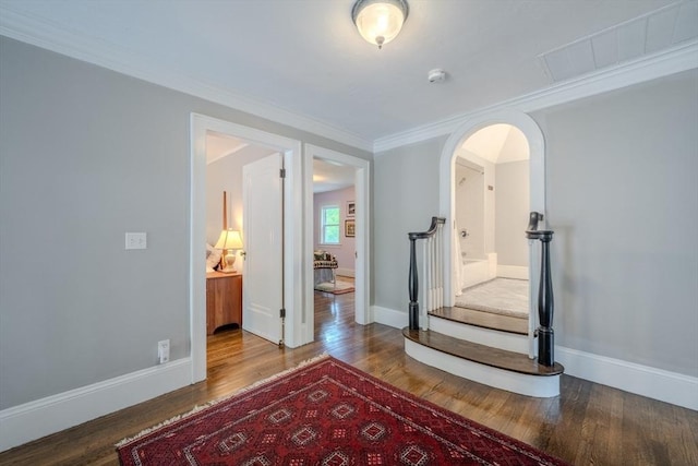 7 Argyle St, Worcester, MA 01609 - hallway with wood finished floors, arched walkways, baseboards, and ornamental molding