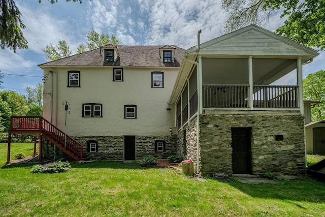 7 Argyle St, Worcester, MA 01609 - rear view of house featuring stairway, stucco siding, a lawn, stone siding, and a sunroom