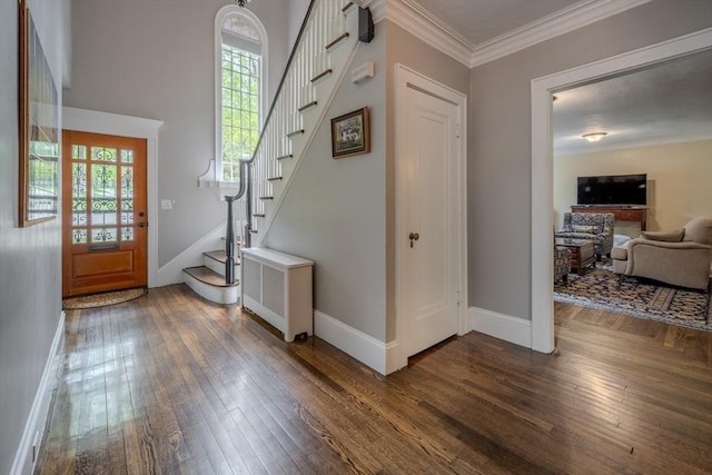 7 Argyle St, Worcester, MA 01609 - entrance foyer with stairway, dark wood-style flooring, radiator heating unit, baseboards, and ornamental molding