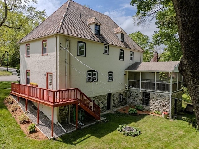 7 Argyle St, Worcester, MA 01609 - back of house with stucco siding, a sunroom, a wooden deck, and an outdoor fire pit
