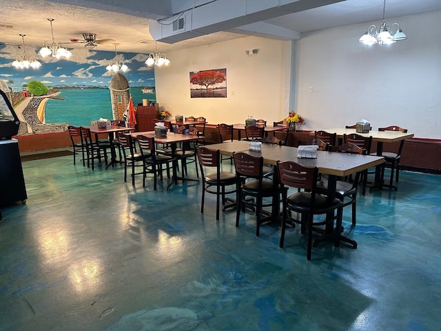 dining space featuring a textured ceiling and concrete floors