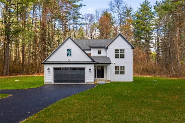 view of front of property with a front yard and a garage