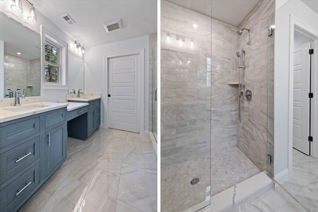 bathroom with vanity and a shower with shower door