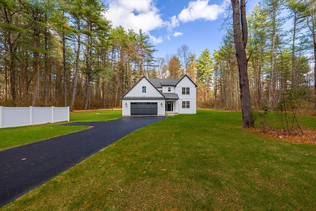 view of front of house featuring a garage and a front lawn