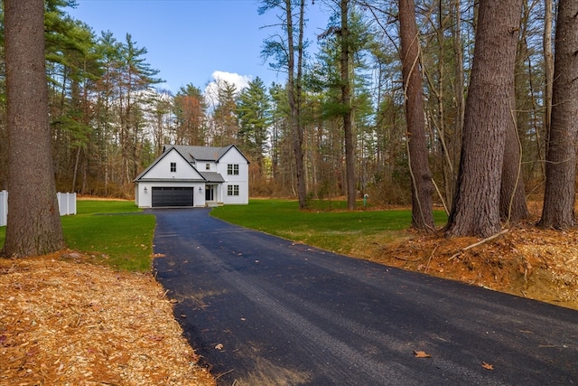 view of front of home with a front lawn and a garage