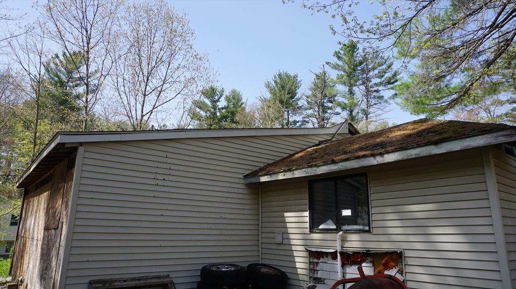 view of side of home with central air condition unit