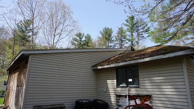 view of side of home with central air condition unit