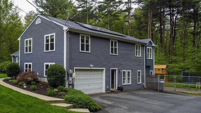 357 Ledge Rd, Seekonk, MA 02771 - view of home's exterior with an attached garage, solar panels, fence, and aphalt driveway