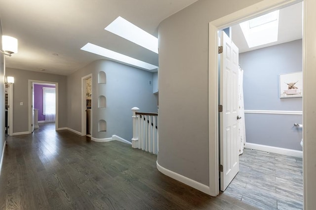 357 Ledge Rd, Seekonk, MA 02771 - hallway featuring baseboards, dark wood-style flooring, an upstairs landing, and a skylight