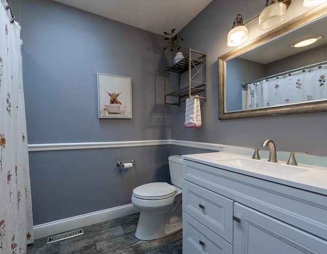 357 Ledge Rd, Seekonk, MA 02771 - bathroom with toilet, wood finished floors, vanity, visible vents, and baseboards