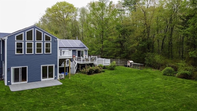 357 Ledge Rd, Seekonk, MA 02771 - back of property with solar panels, a yard, a deck, and stairs