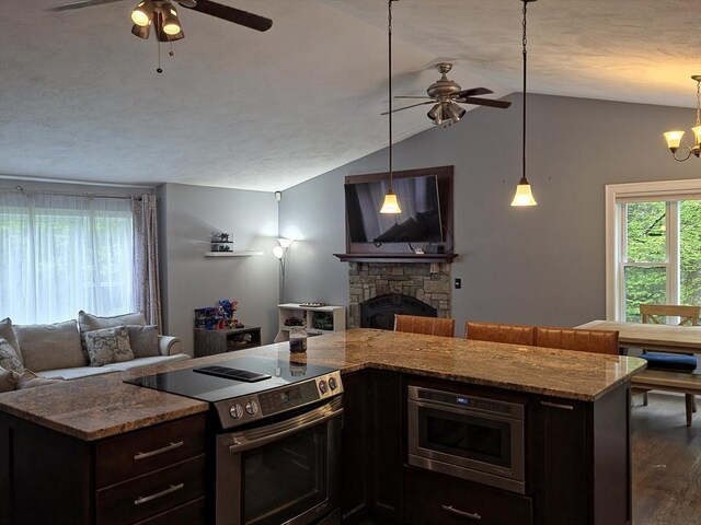 357 Ledge Rd, Seekonk, MA 02771 - kitchen with appliances with stainless steel finishes, vaulted ceiling, ceiling fan with notable chandelier, and open floor plan