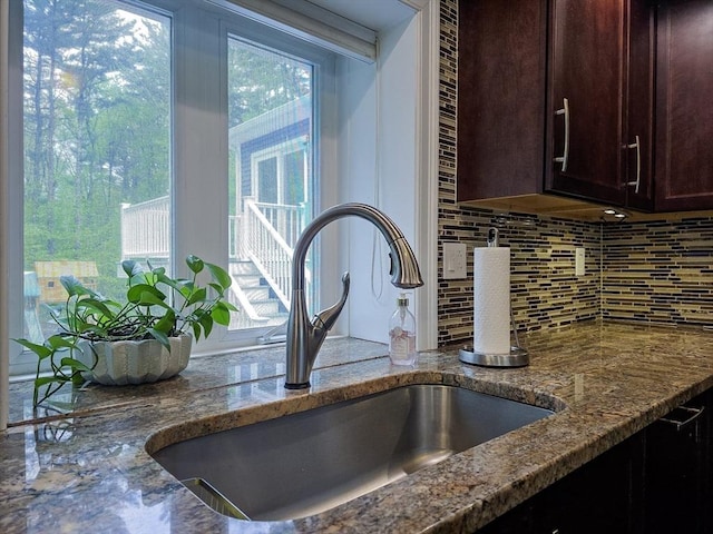 357 Ledge Rd, Seekonk, MA 02771 - interior details with a sink, dark brown cabinetry, decorative backsplash, and dark stone countertops