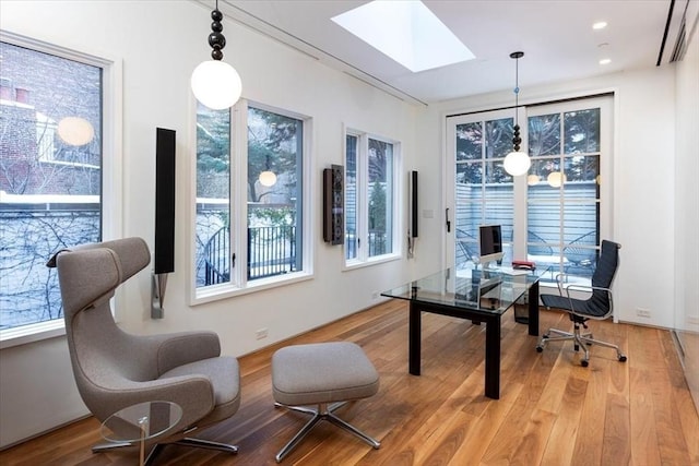 office featuring recessed lighting, a skylight, and wood finished floors