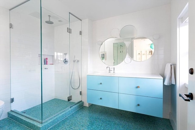 bathroom featuring a stall shower, tile patterned flooring, and vanity