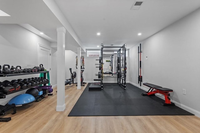 workout room with light hardwood / wood-style flooring